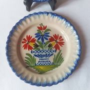 Pair of antique plates in popular earthenware with a floral basket decoration on the edge.