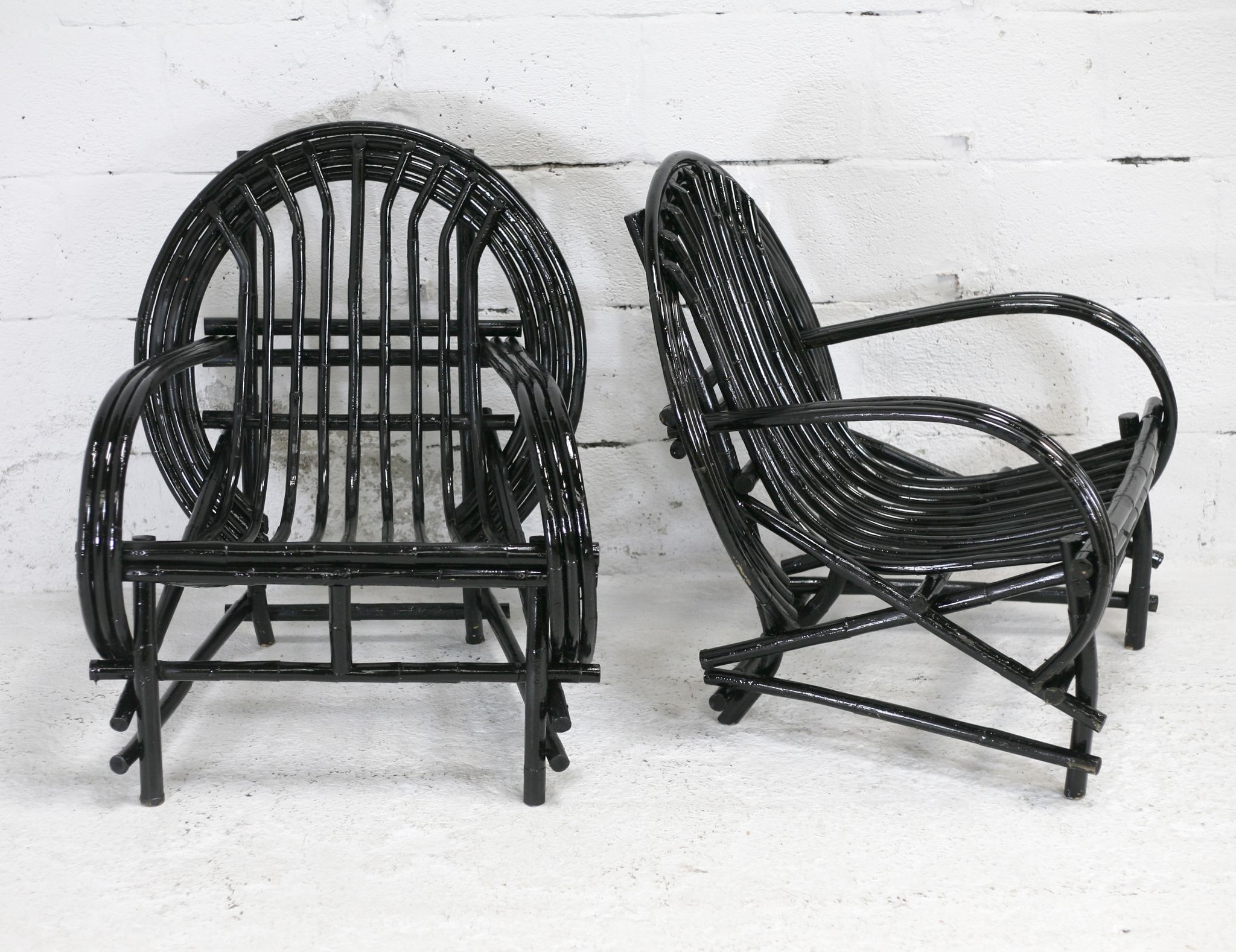 Pair of black lacquered rattan armchairs. France, cira 1960.