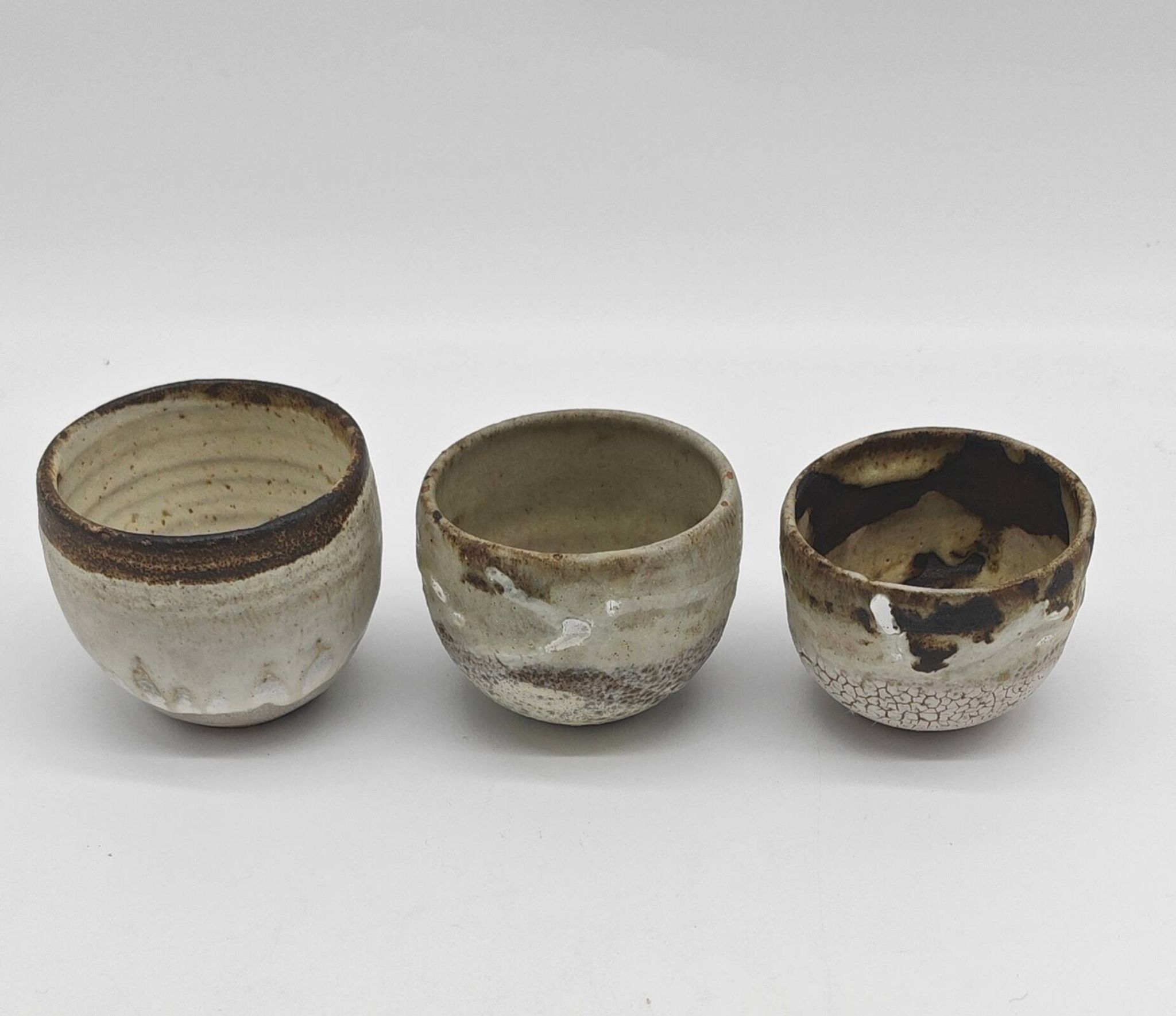Trilogy of cups or Japanese-style goblets by the Danish ceramist Gutte Eriksen using RAKU technique.