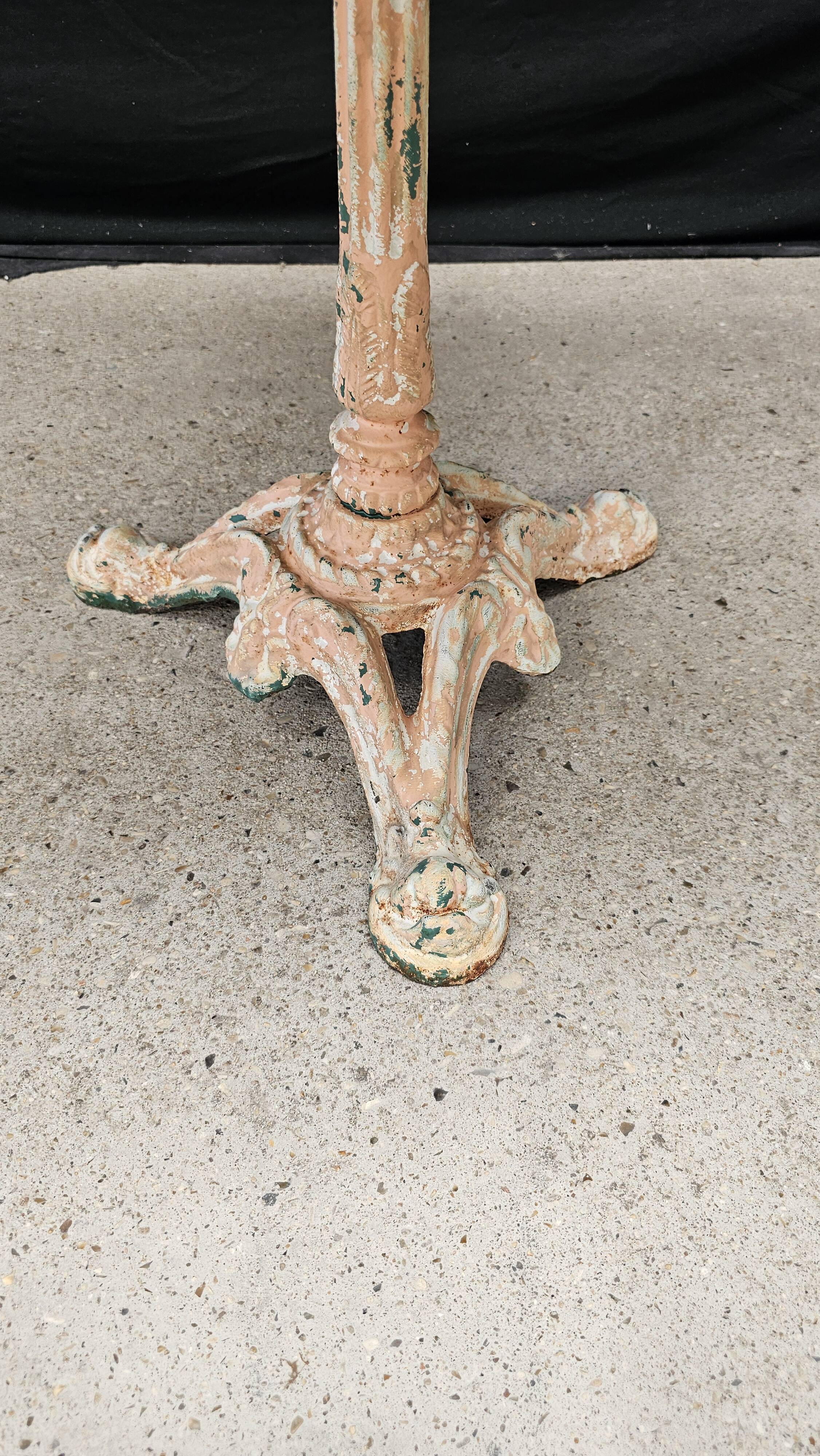 Bistro table with cast iron base and solid teak top