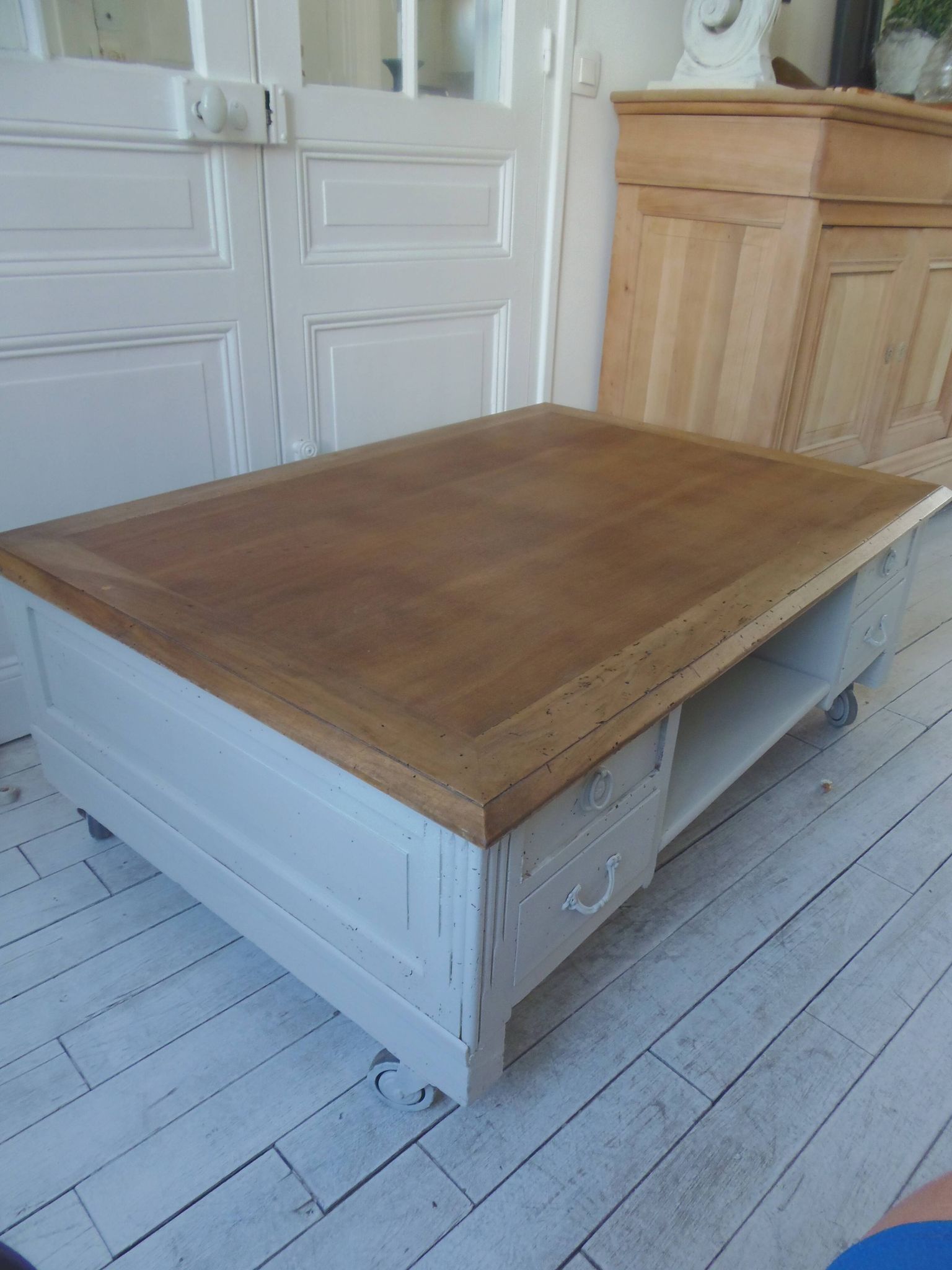 Coffee table on casters, made from an old desk, pearl gray base and belt.