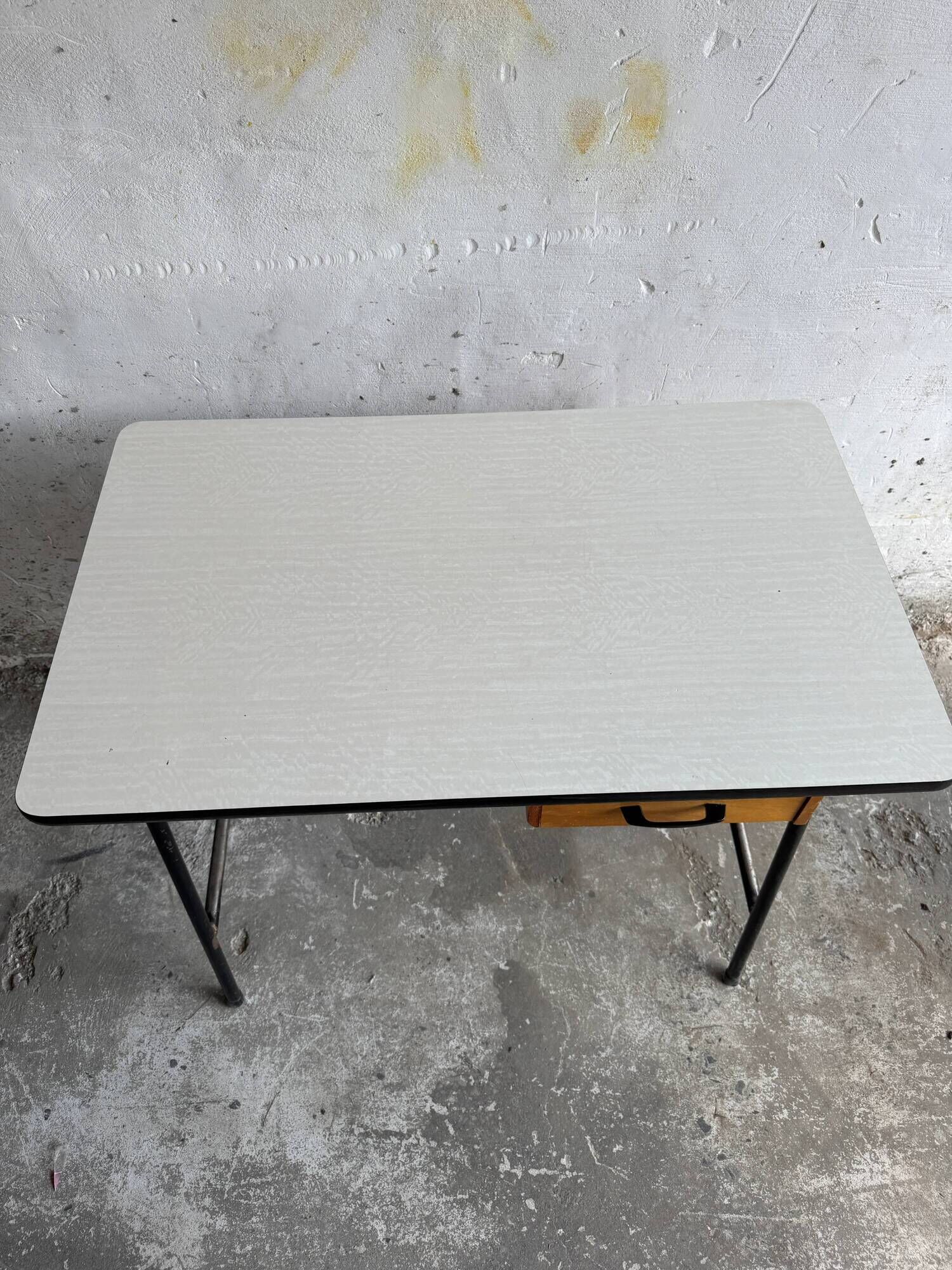 Black metal and wood mid-century industrial desk with laminated top and two drawers