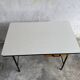 Black metal and wood mid-century industrial desk with laminated top and two drawers