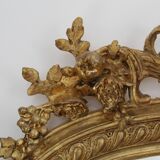 Large 19th-century wooden and gilt-studded mirror decorated with a cornucopia motif.
