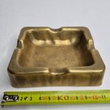 Empty pocket brutalist-inspired ashtray in gilded bronze