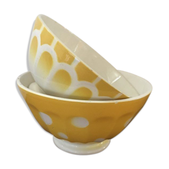 2 matching bowls decorated in yellow and white
