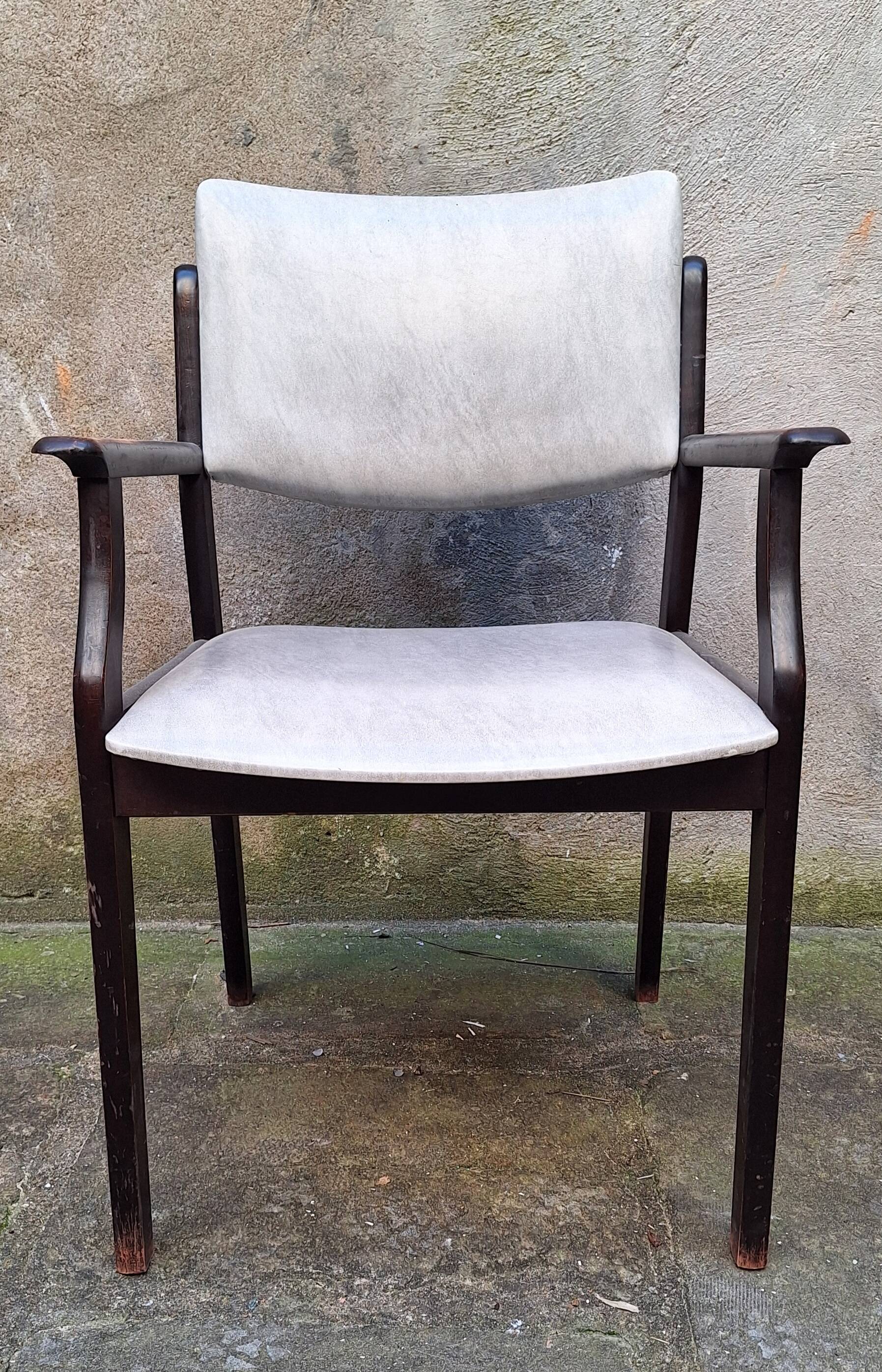 Wooden armchair and faux leather.