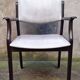 Wooden armchair and faux leather.
