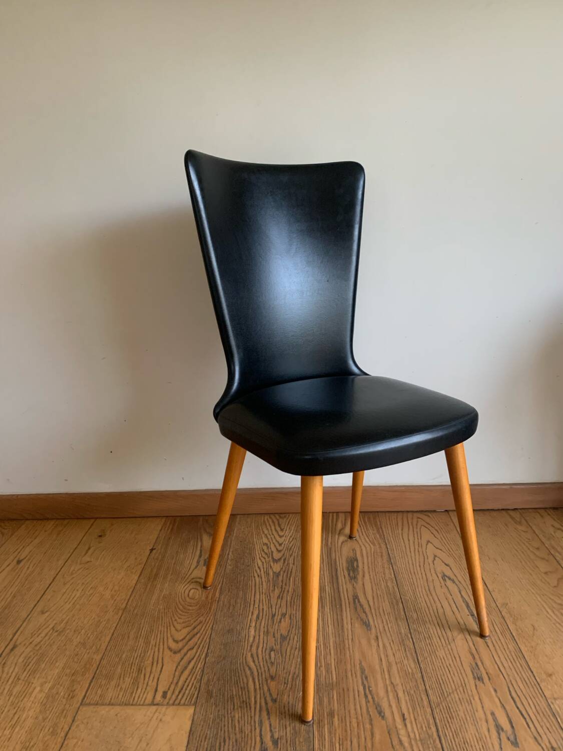 Black chair with compass legs