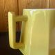 Vintage yellow ceramic teapot and milk jug.