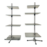 A pair of vintage side tables in glass and chrome metal.