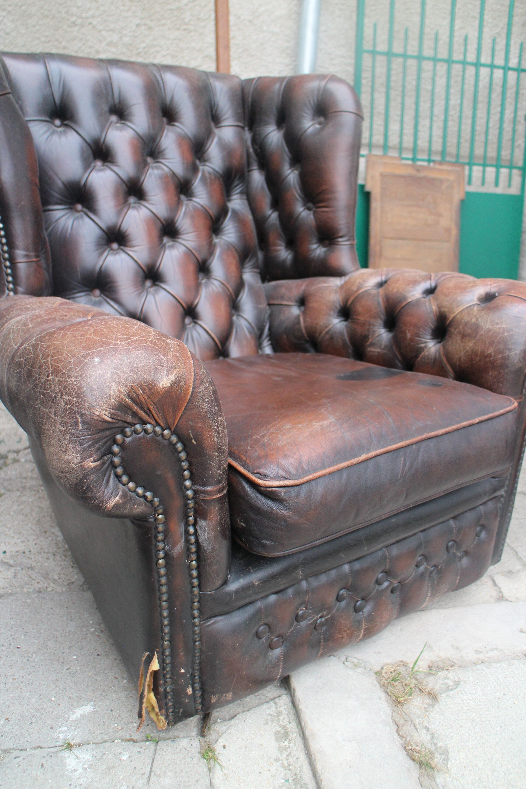 Padded chesterfield leather armchairs