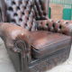 Padded chesterfield leather armchairs