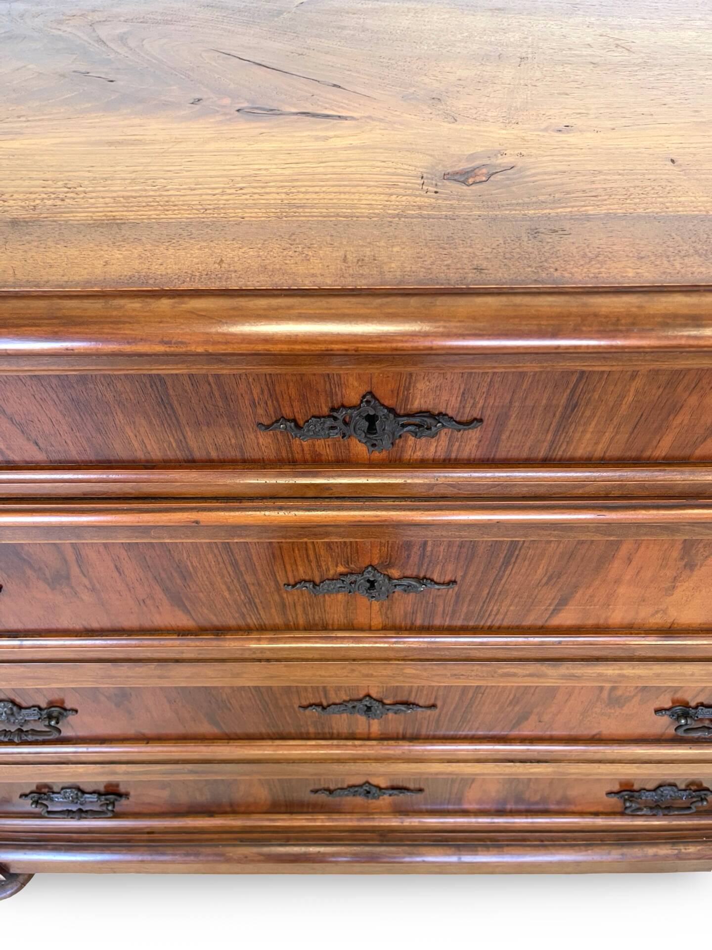 Antique walnut commode with bronze handles in the shape of a lion's mask,