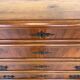 Antique walnut commode with bronze handles in the shape of a lion's mask,