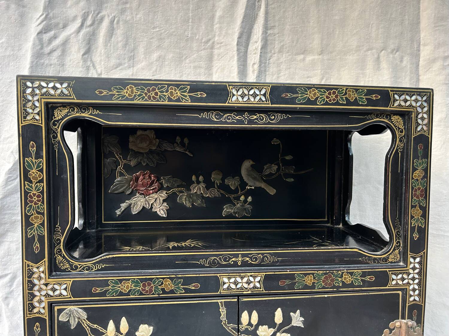 Chinese sideboard with gold lacquer and mother-of-pearl inlay. Bird and landscape decor.