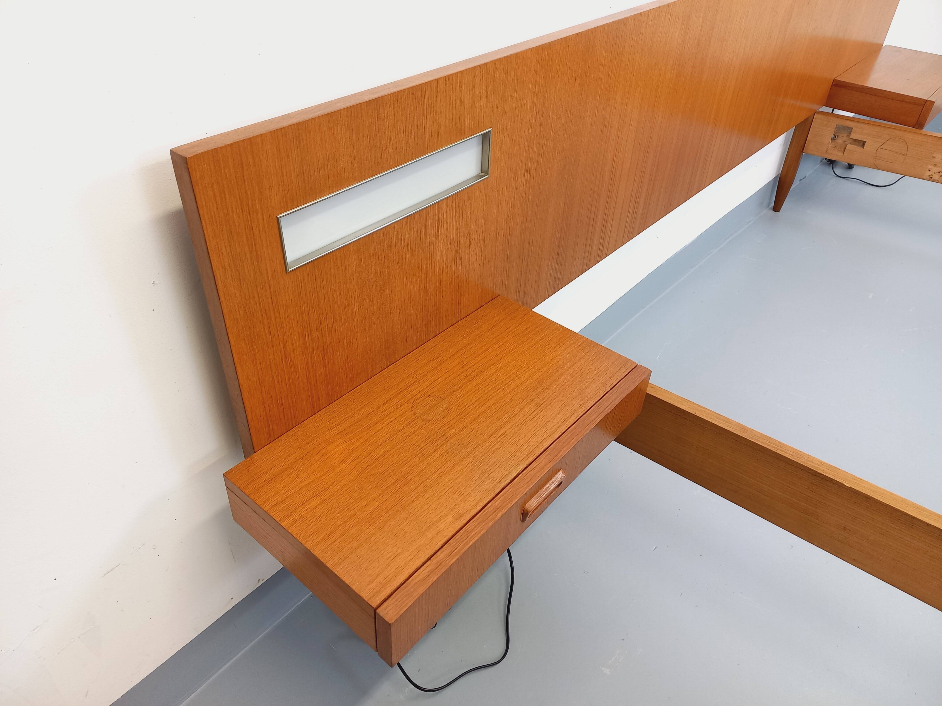 Double bed in vintage Scandinavian style from the 1960s with bedside tables.