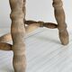 Antique wooden stool with four turned legs.