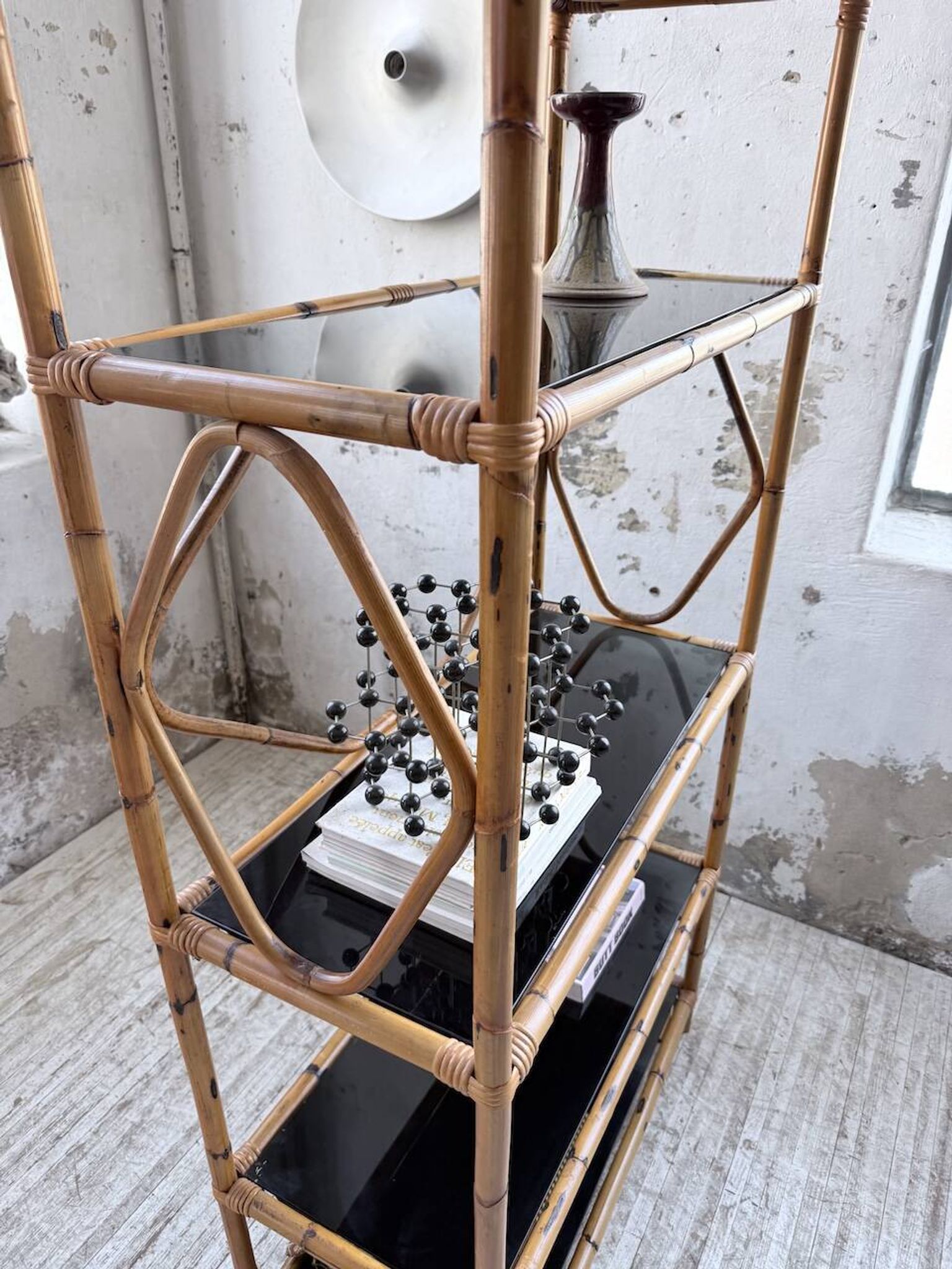 Rattan bookshelf and black glasses