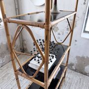 Rattan bookshelf and black glasses
