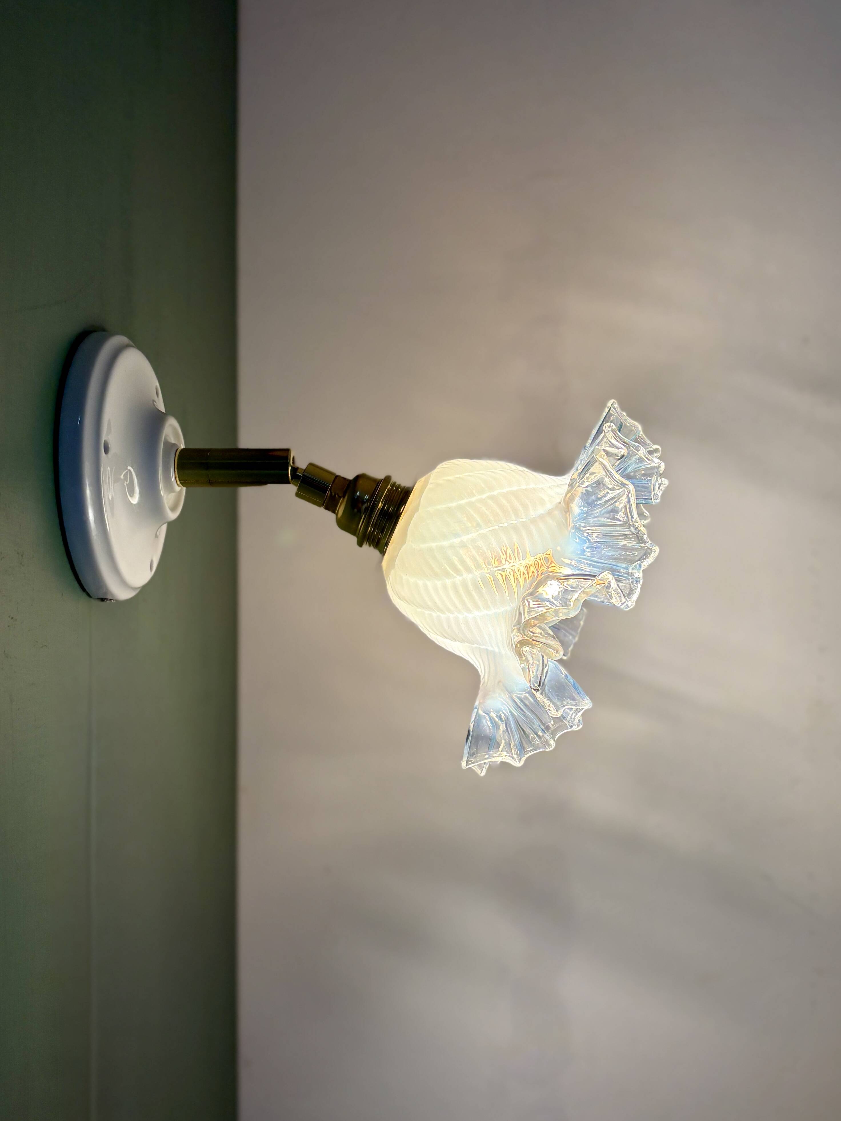 Vintage tulip glass wall light in transparent, slightly pearlescent white.