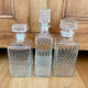 Set of 3 vintage whisky carafe bottles in molded glass