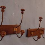 Pair of double coat hooks from the end of the 19th century, circa 1900, in wood and varnished metal