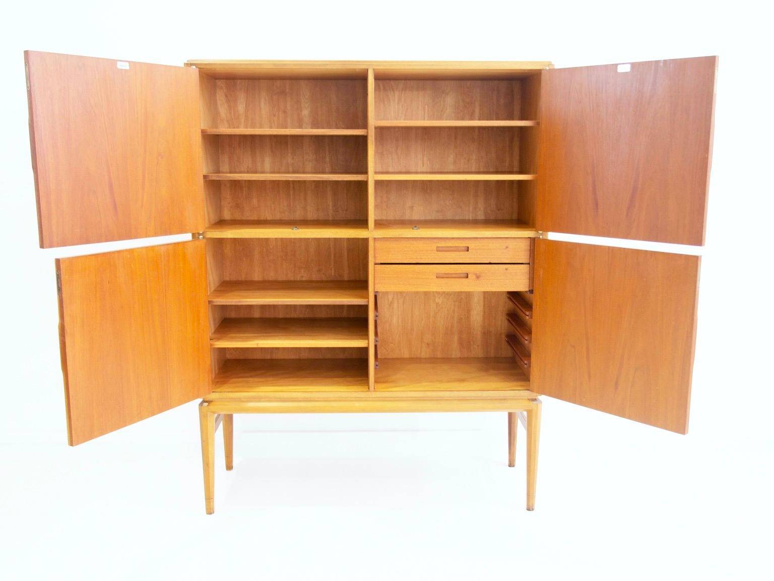 Large Swedish mahogany storage unit with four front doors.