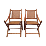 Pair of folding chairs in bamboo and caning, leather and brass