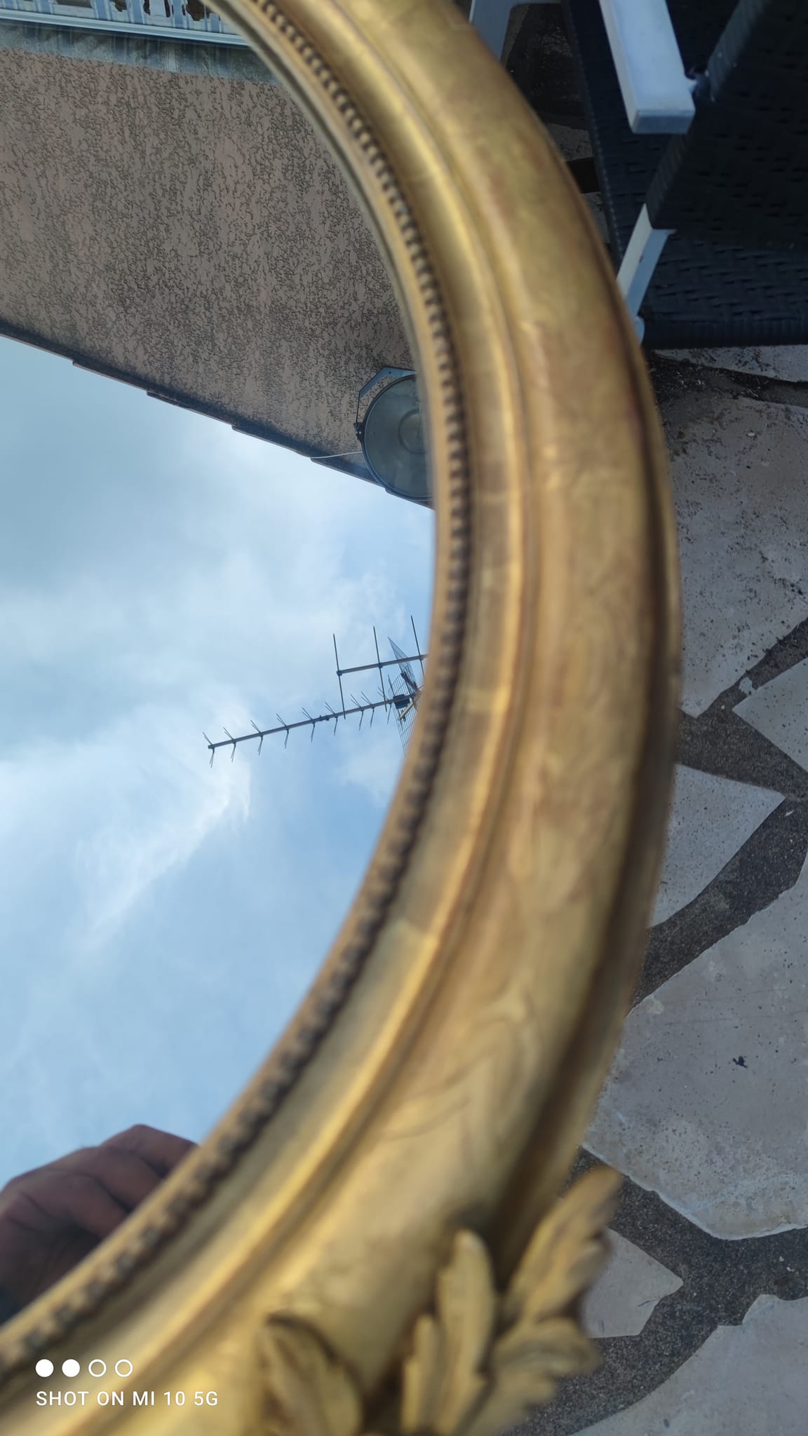Ovoid mirror with double gilt pediments, circa 1830, 105x66 cm
