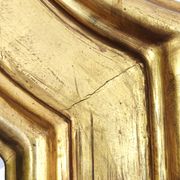 Florentine arched mirror in gilded wood with gold leaf.