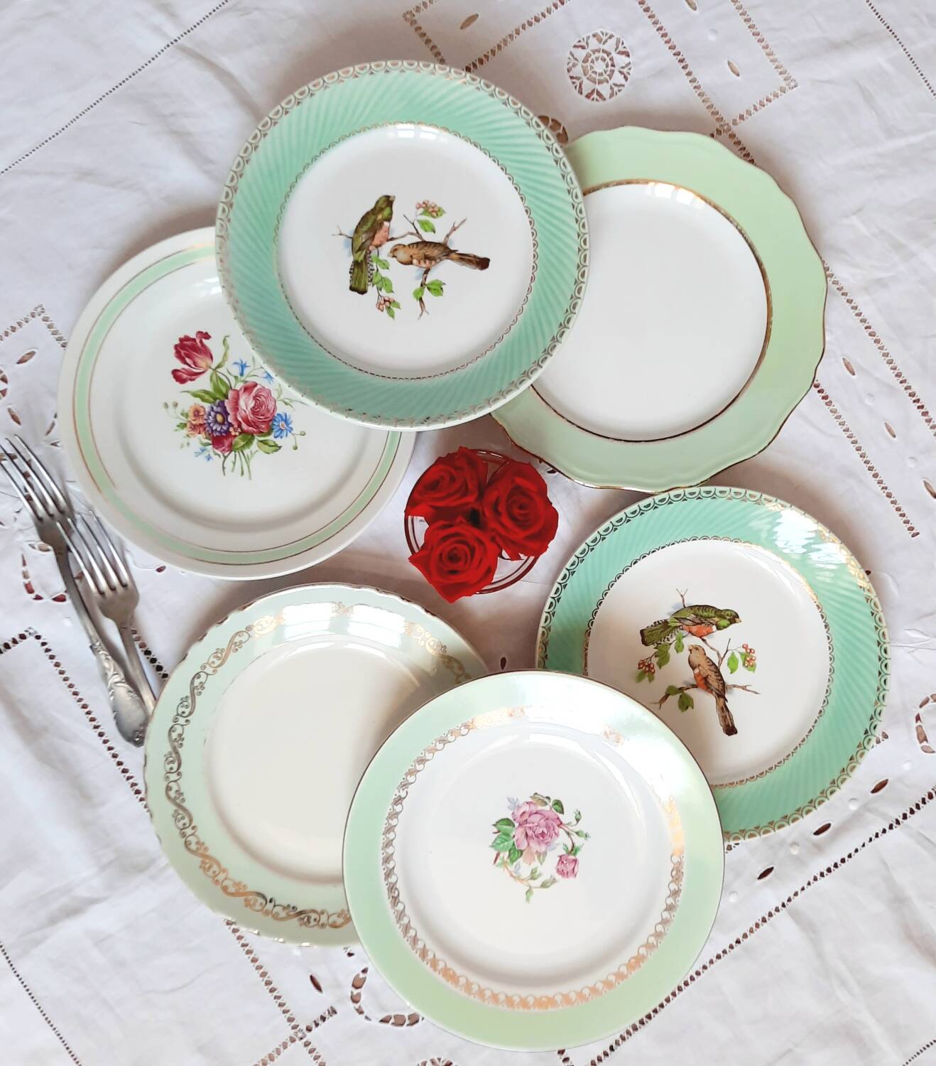 Old mismatched earthenware dinner plates with gold accompanied by a dish