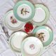 Old mismatched earthenware dinner plates with gold accompanied by a dish