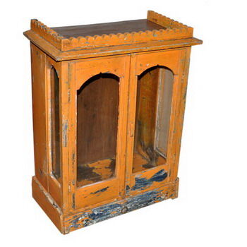 Old temple-showcase with teak offerings