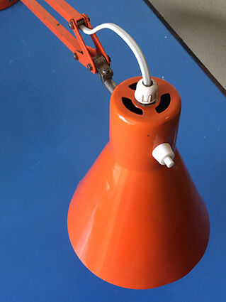 Luxo L9 orange single-arm lamp on plinth