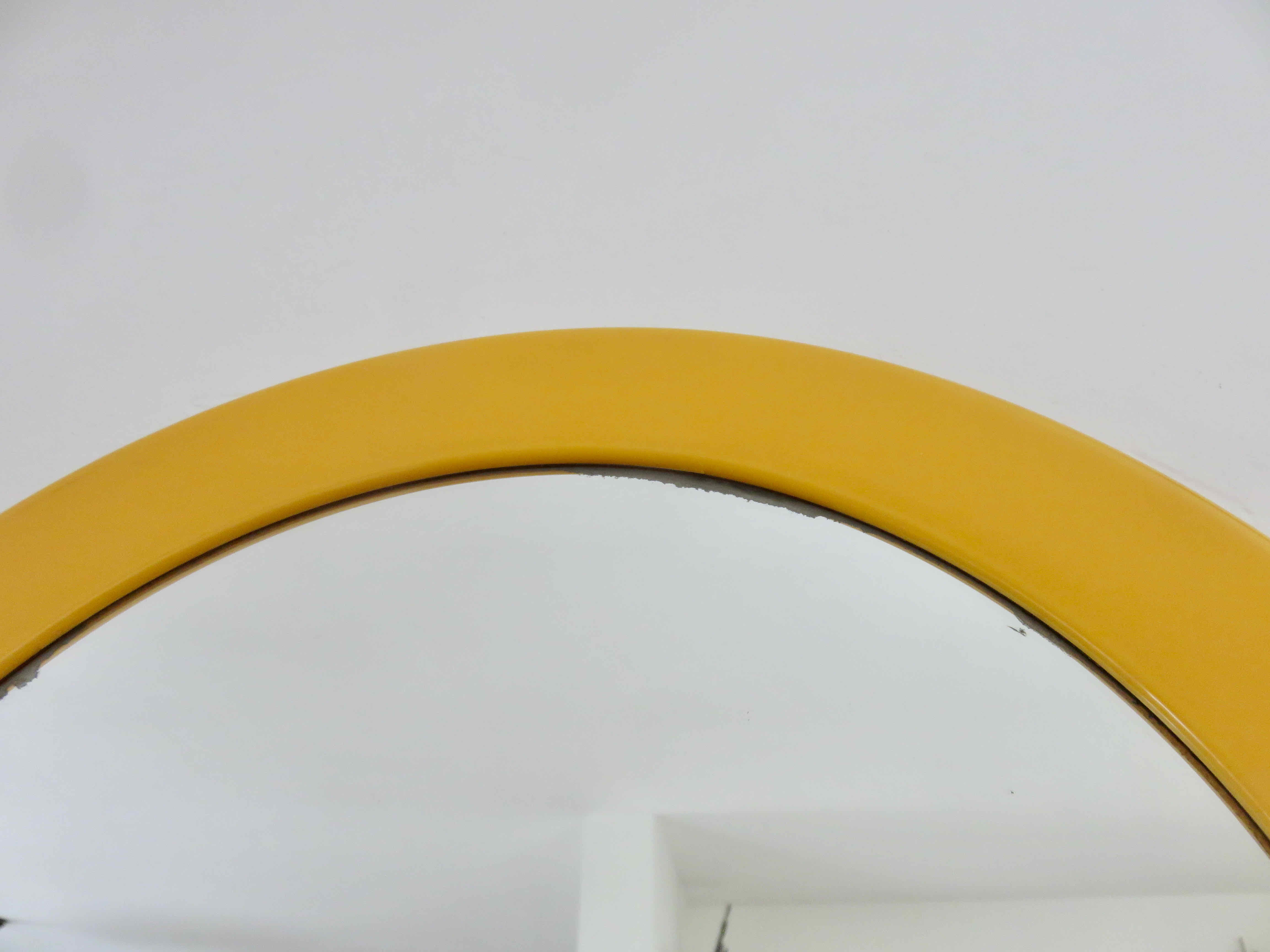 Round wall mounted mirror in yellow plastic 1970