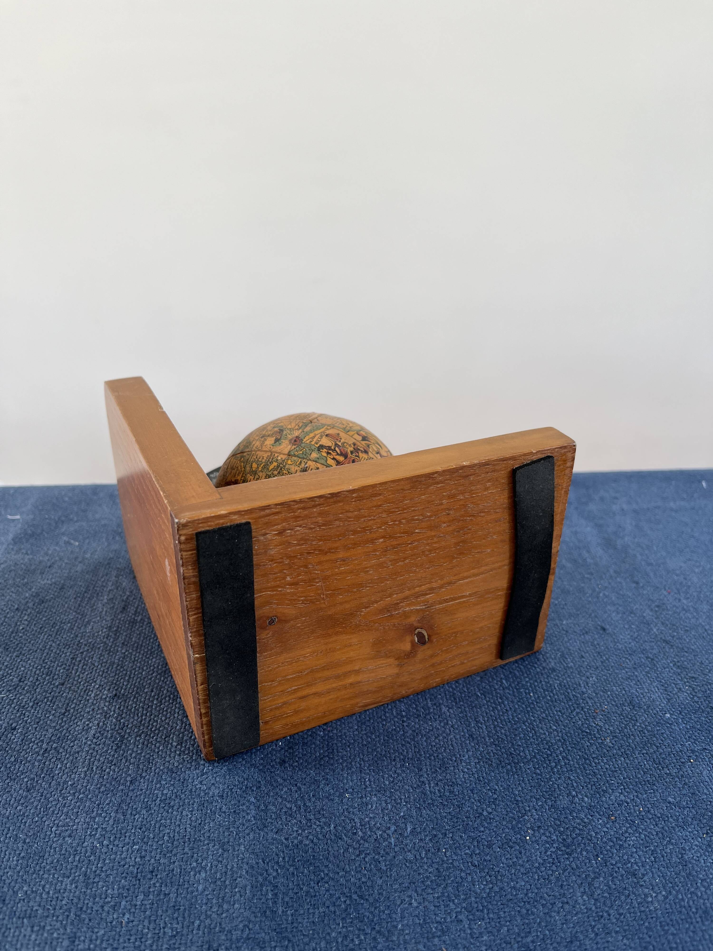 Rotating globe bookends on wooden base