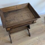 Old wooden pocket emptying table with drawer and planter.