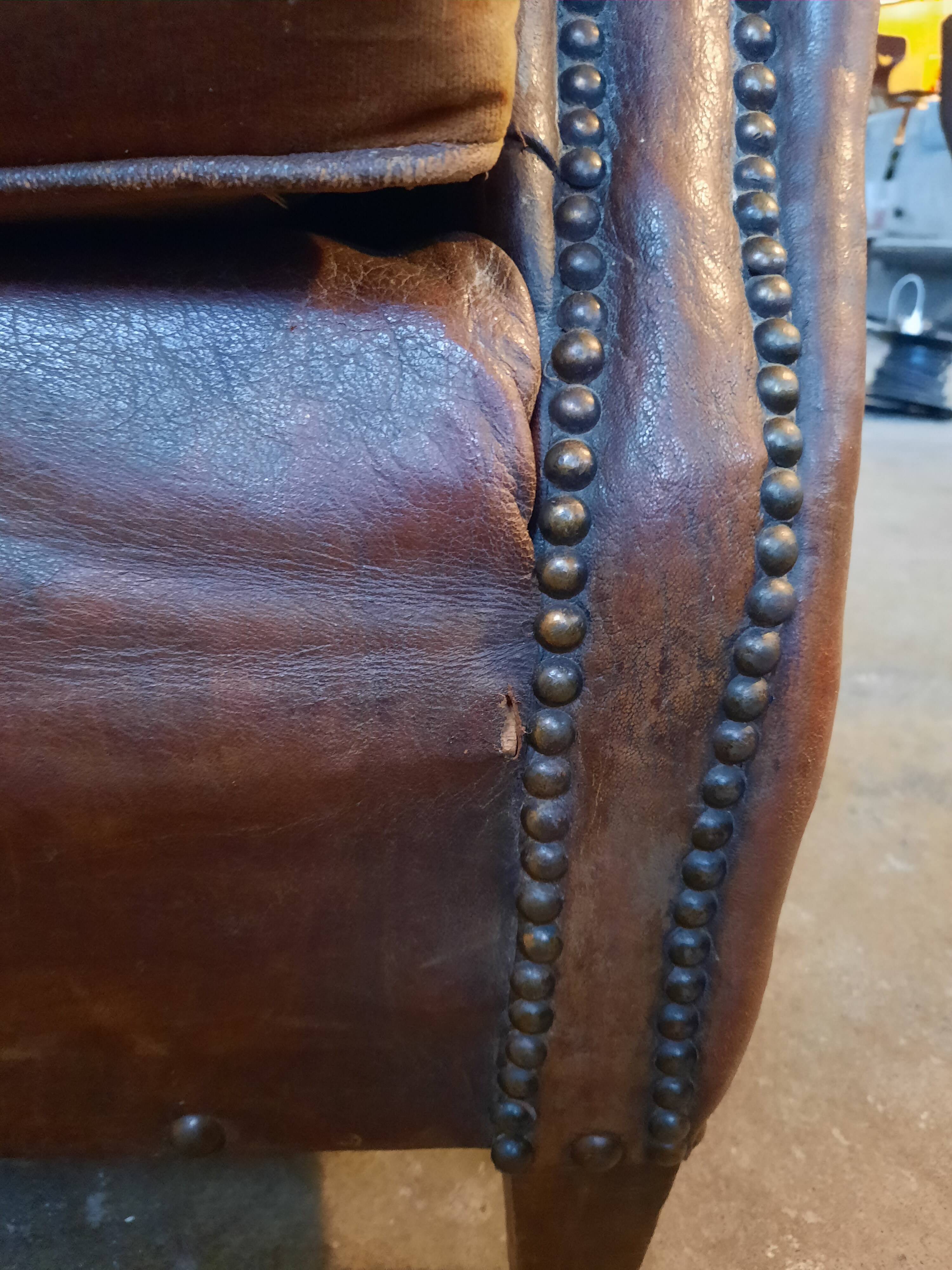Old studded leather club chair 1930-1930