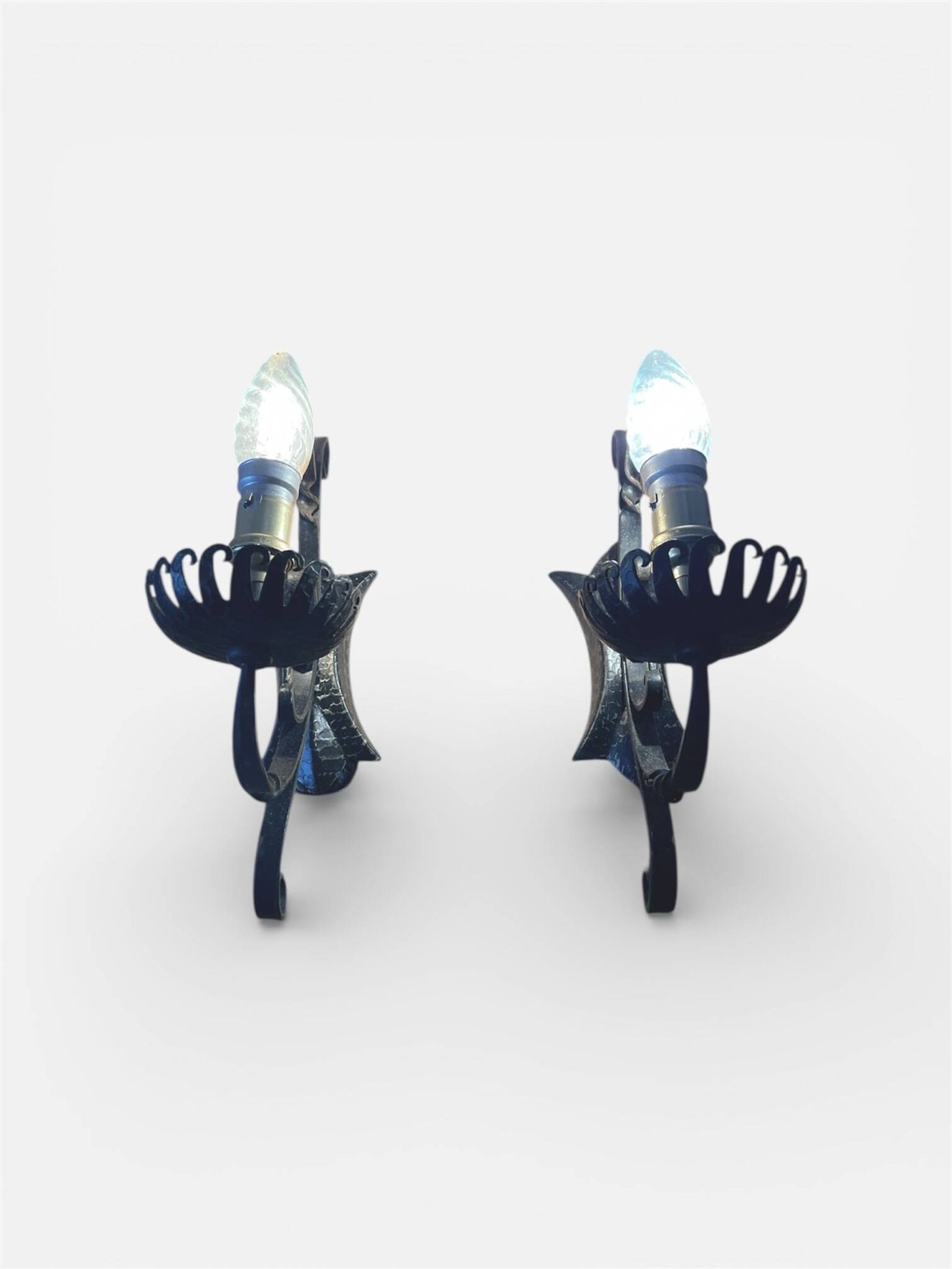 Vintage wrought iron wall lights in rustic gothic style.