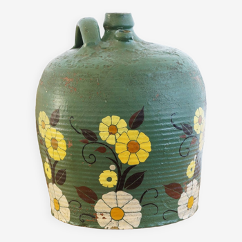 Old terracotta jug painted green