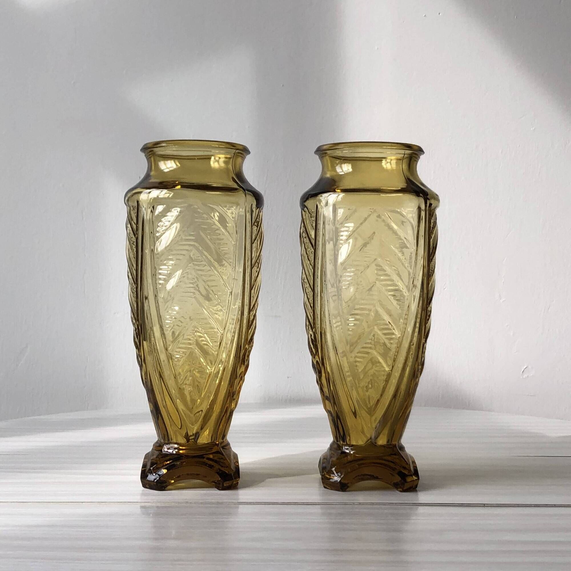 Duo of art deco vases in yellow glass with scroll patterns
