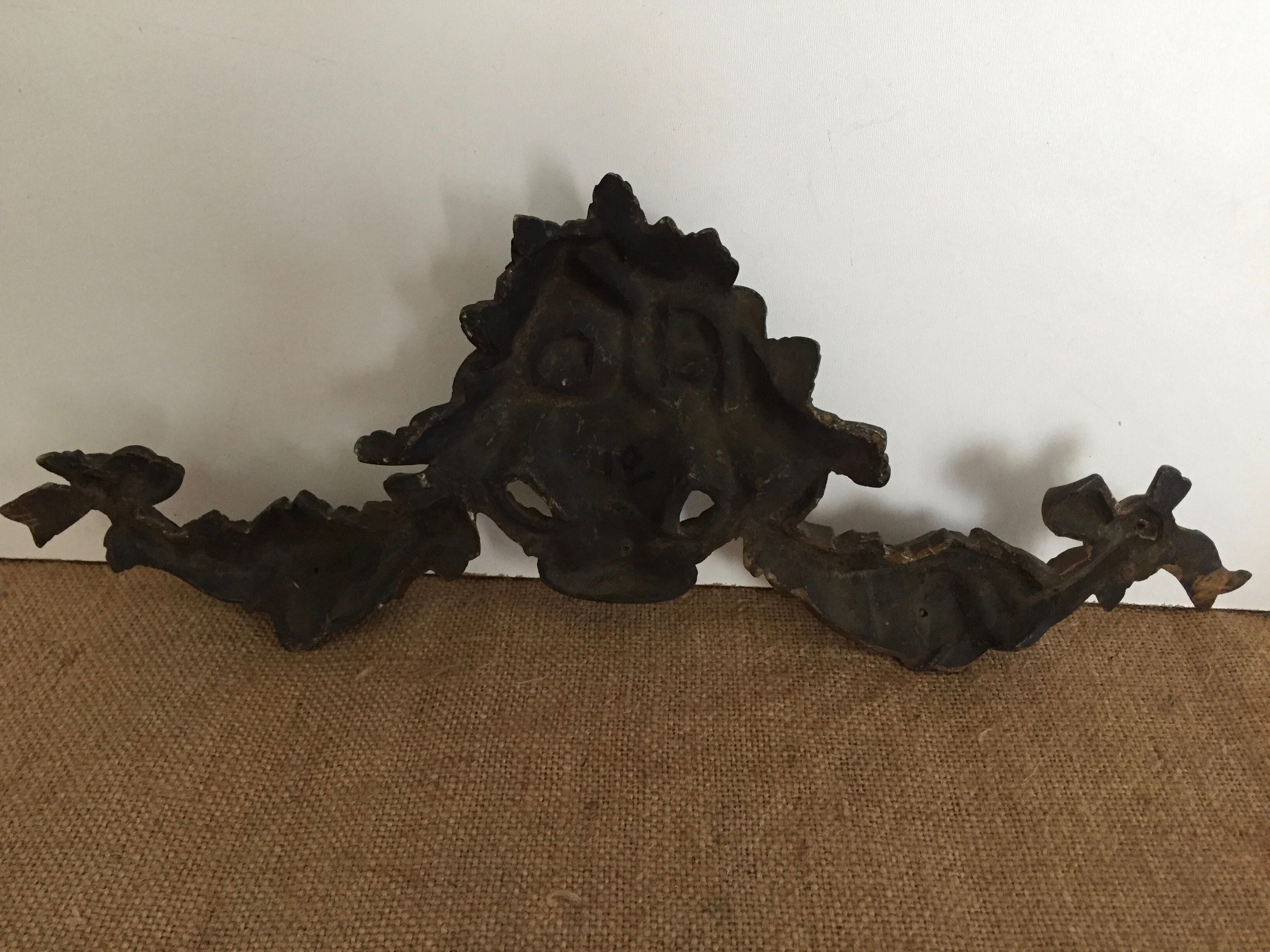 Old brass pediment, floral motifs and ribbon