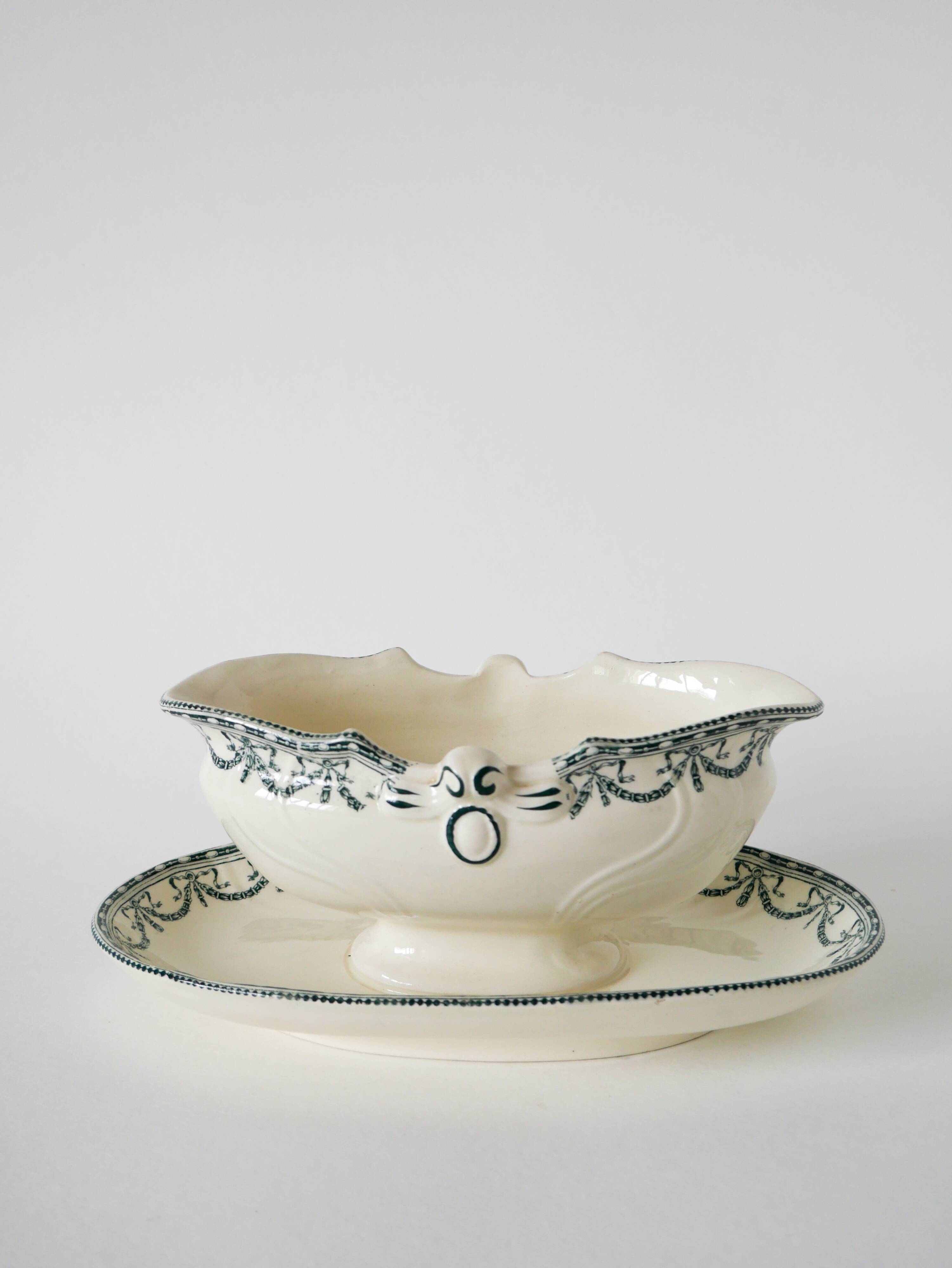 Sauce boat in Salins Iron Earth, "Guirlandes" model, textured version, early 20th century