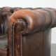 Brown Chesterfield armchair made of cowhide leather in English style