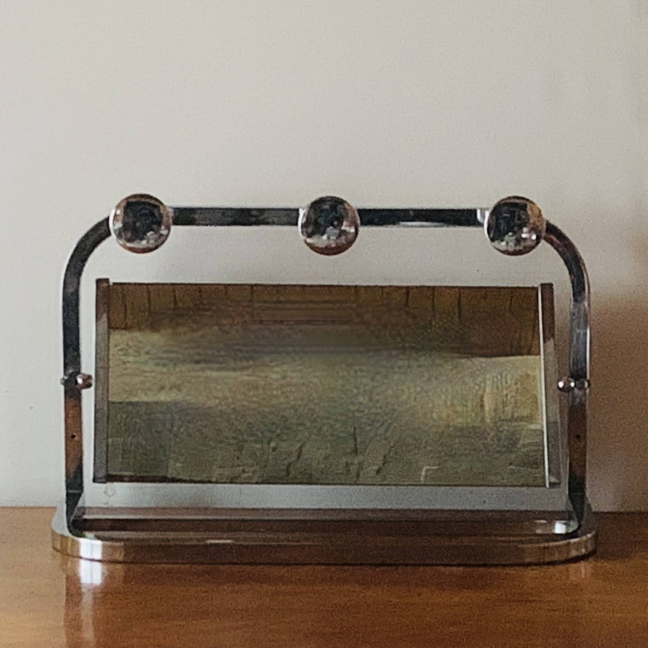 Vintage wall-mounted coat rack in chrome metal with integrated mirror and hat rack
