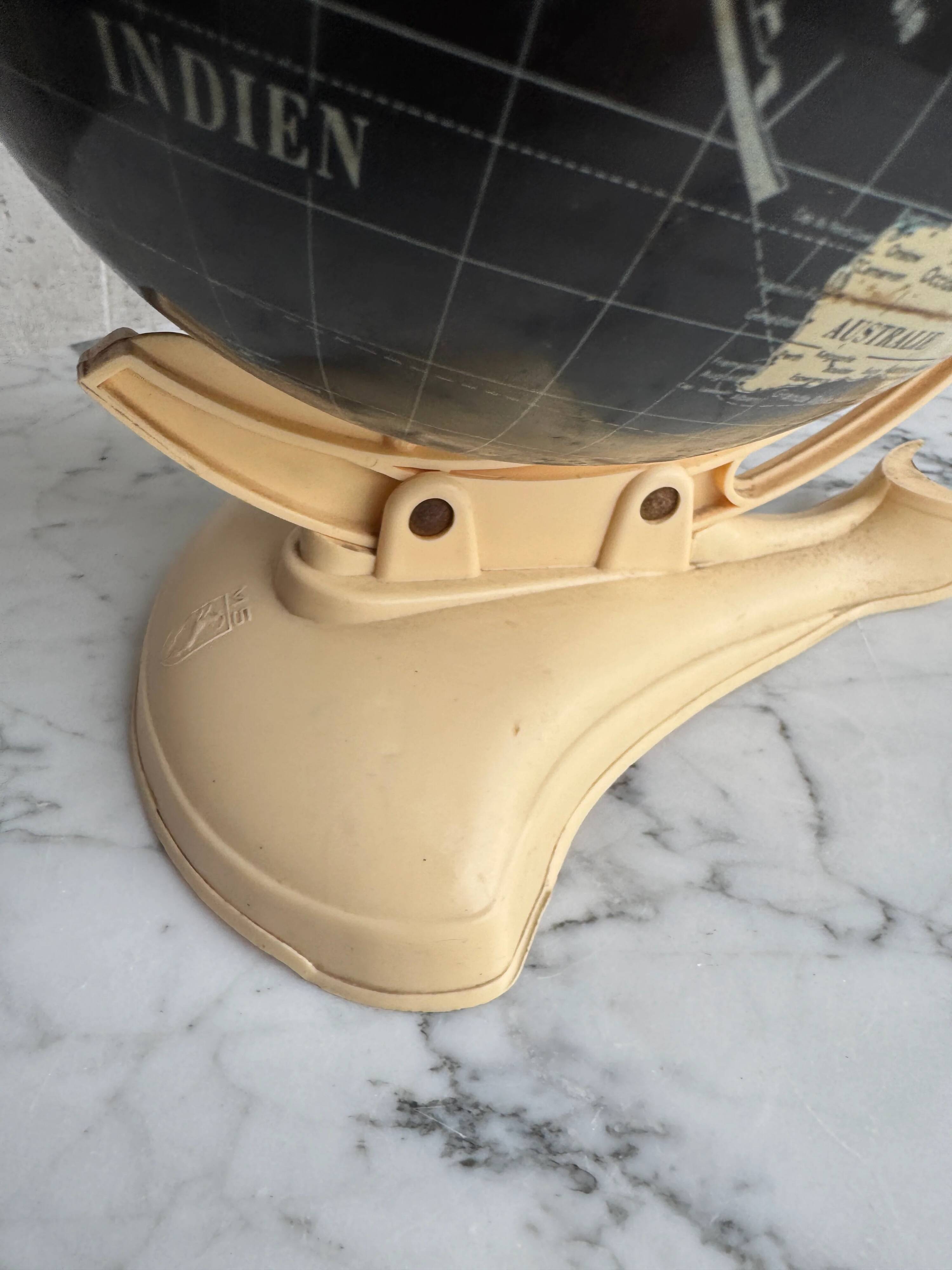 French mid-century school globe with black oceans on printed paper, cream plastic base