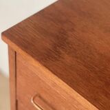 Vintage 1960s chest of drawers with covered handles.