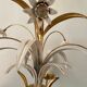 Golden metal chandelier decorated with flowers