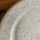 Four beige speckled plates